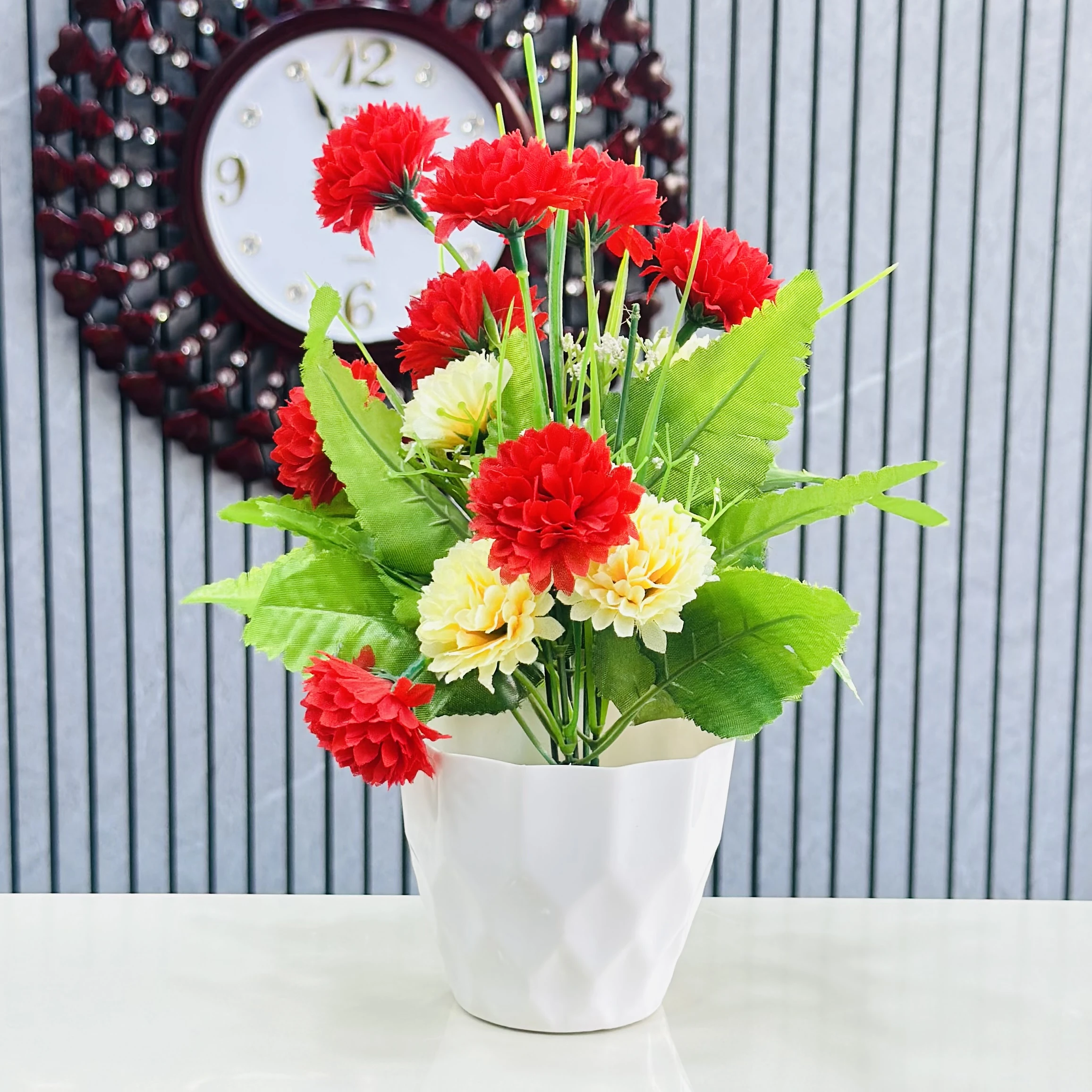 carnation flower arrangement in a white ceramic-like pot.