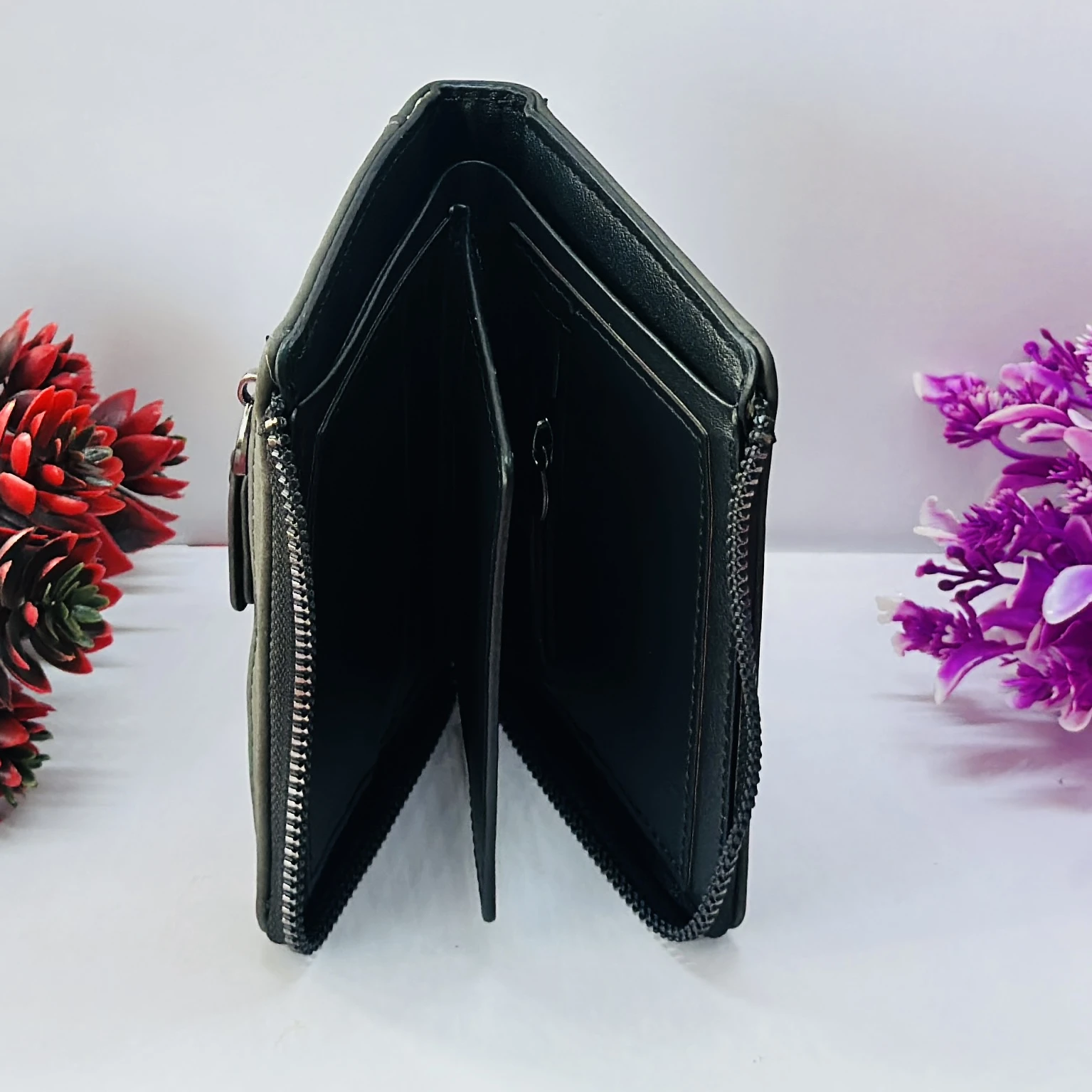 compact men's wallet with a secure zip closure, made from vegan leather.