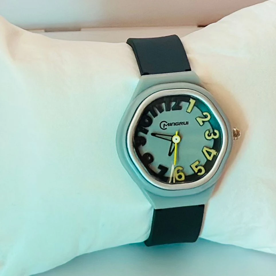 Mingrui analog watch with an asymmetric, "melted" dial and black silicone strap.