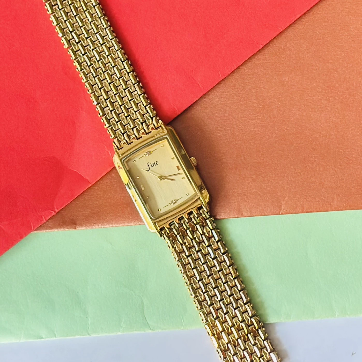 Gold -tone analog quartz watch with a metal strap.