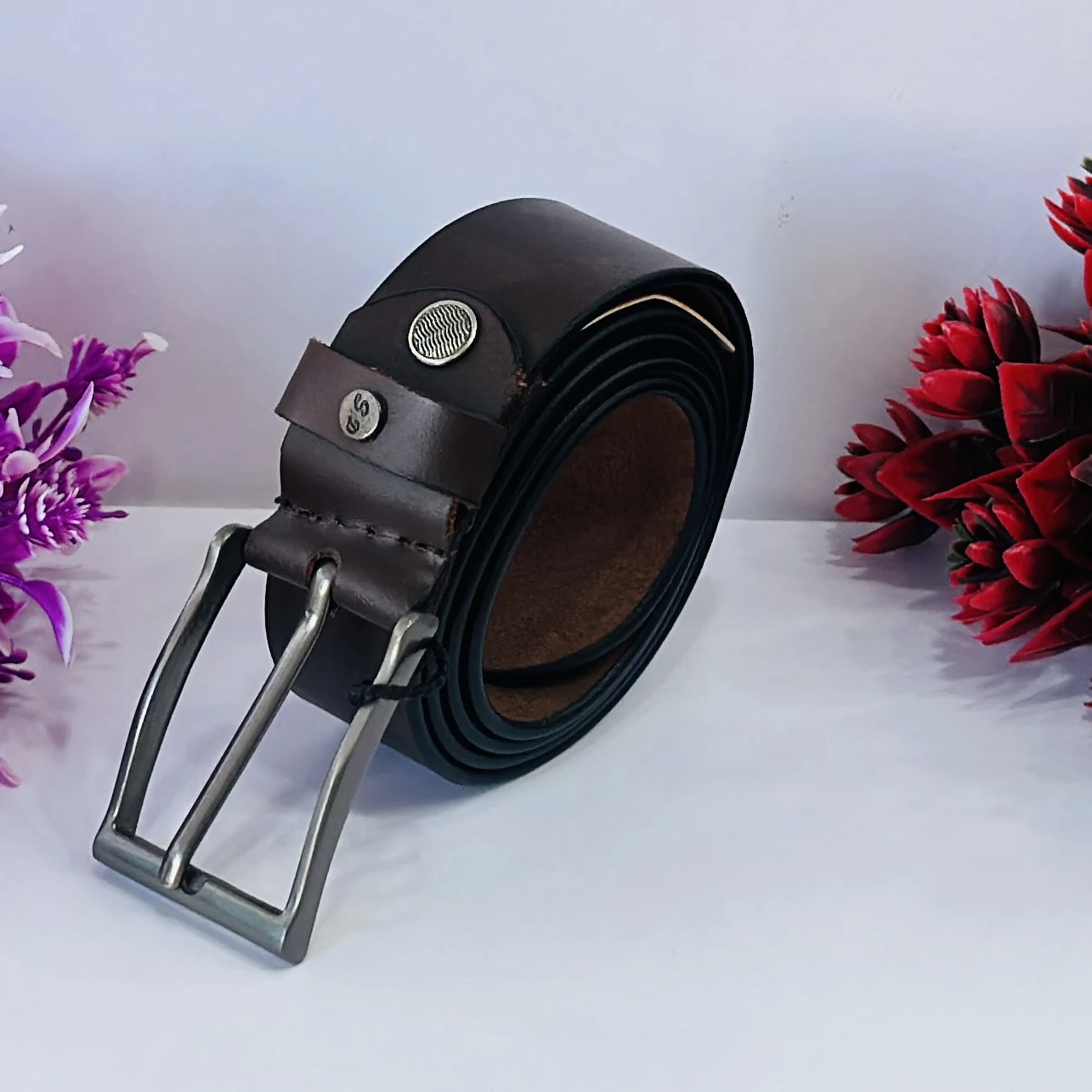 Brown leather belt with a metal buckle