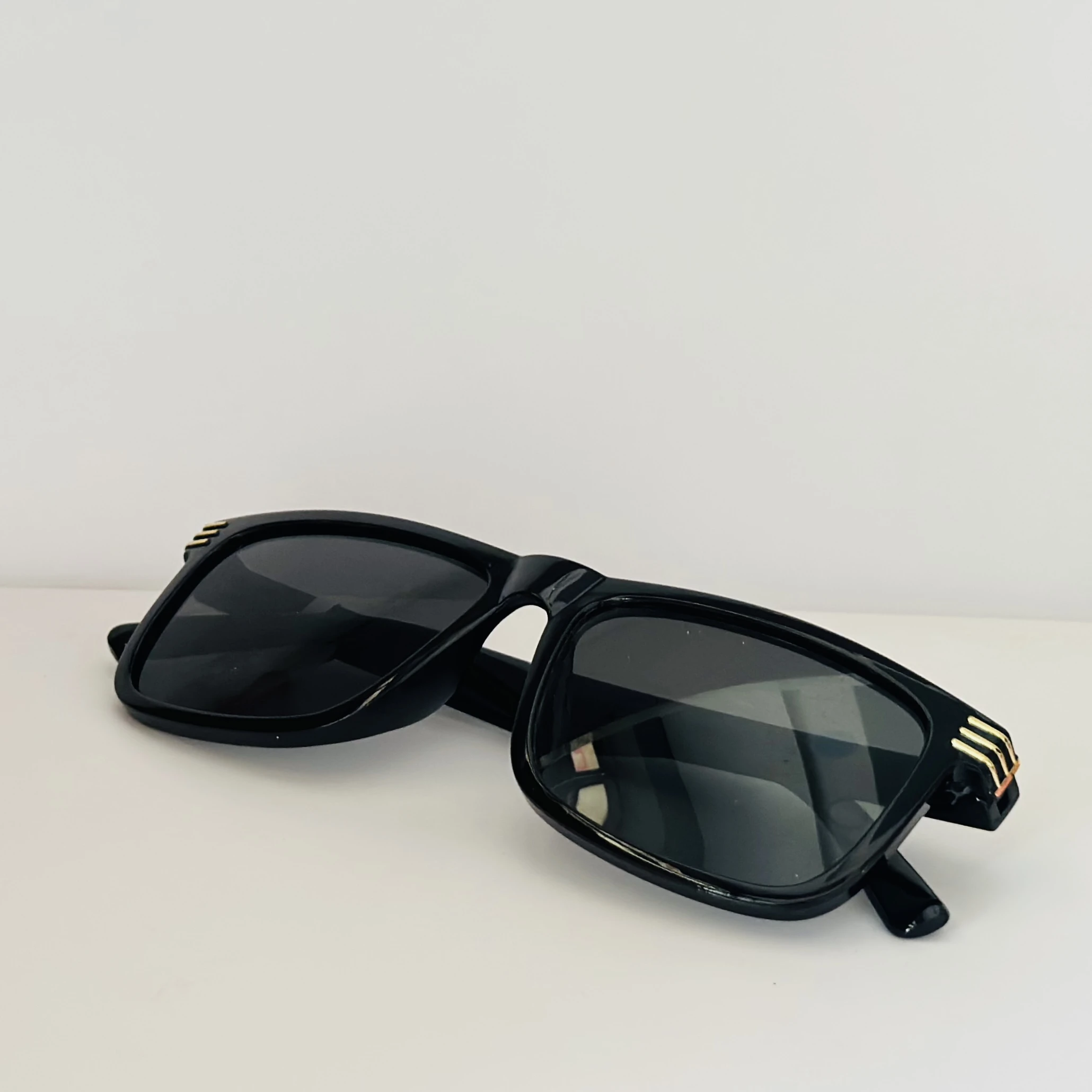 Saint Laurent SL 710 OPT eyeglasses with a black acetate frame and gold-toned details.