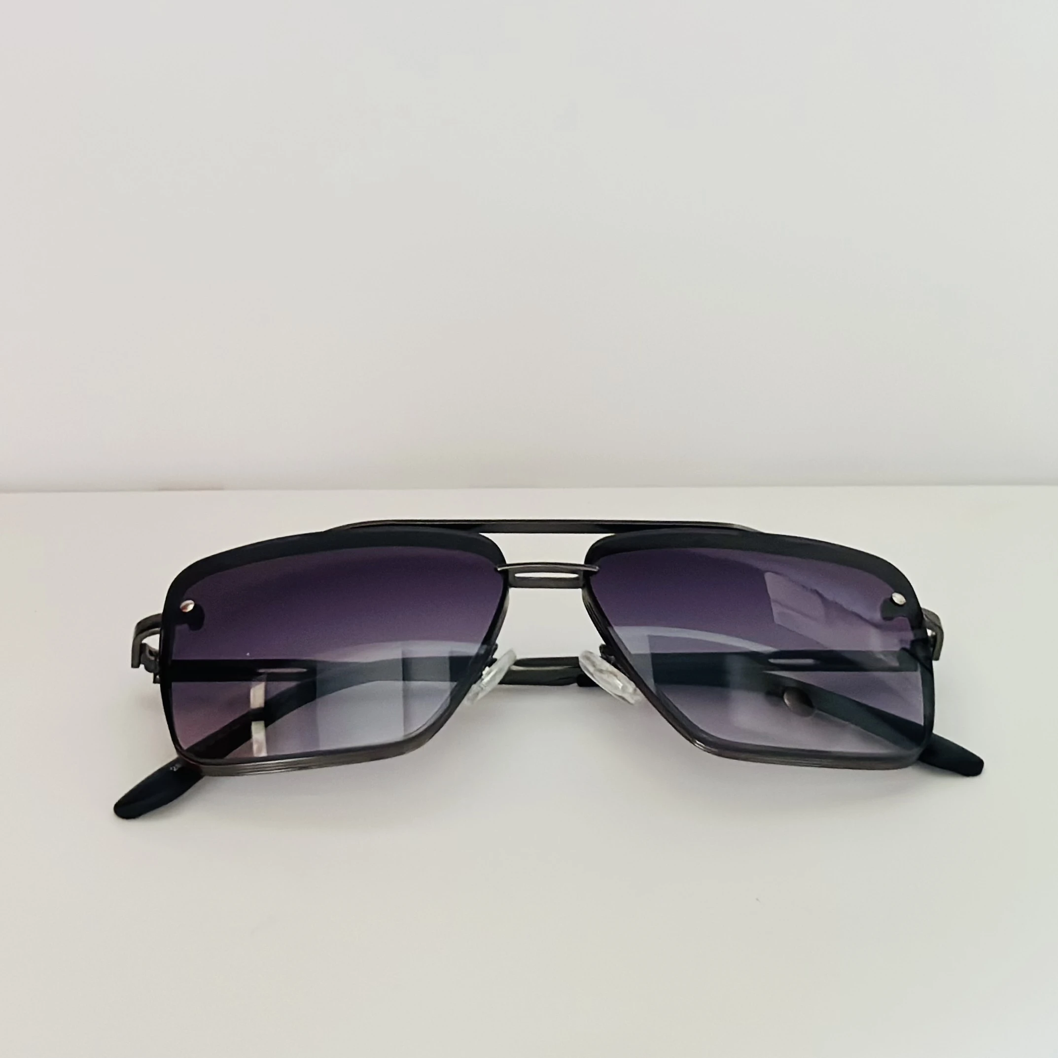 Black metal-framed square sunglasses with gradient lenses.
