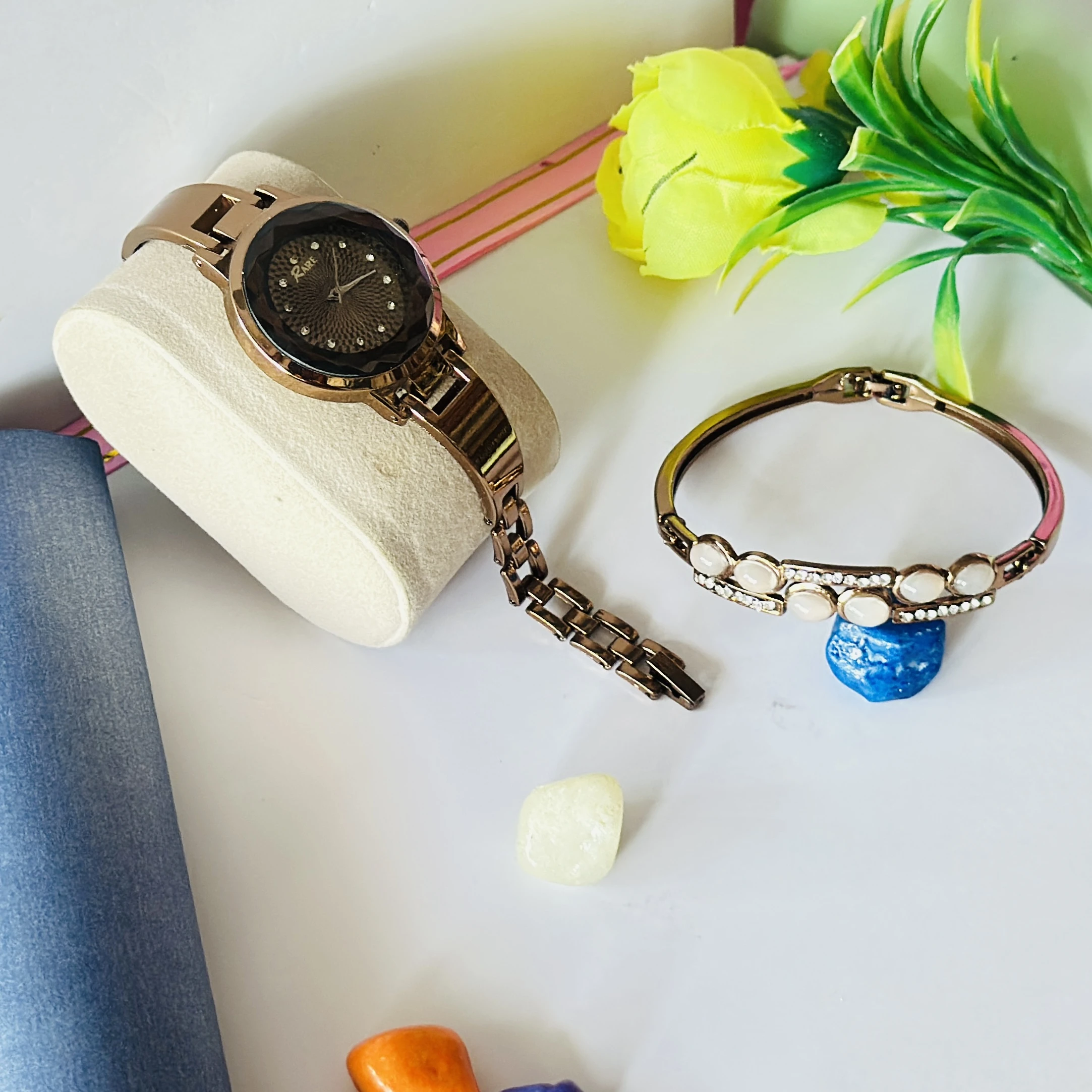 Rose gold-tone ladies wristwatch with a crystal-embellished round dial and bracelet strap.