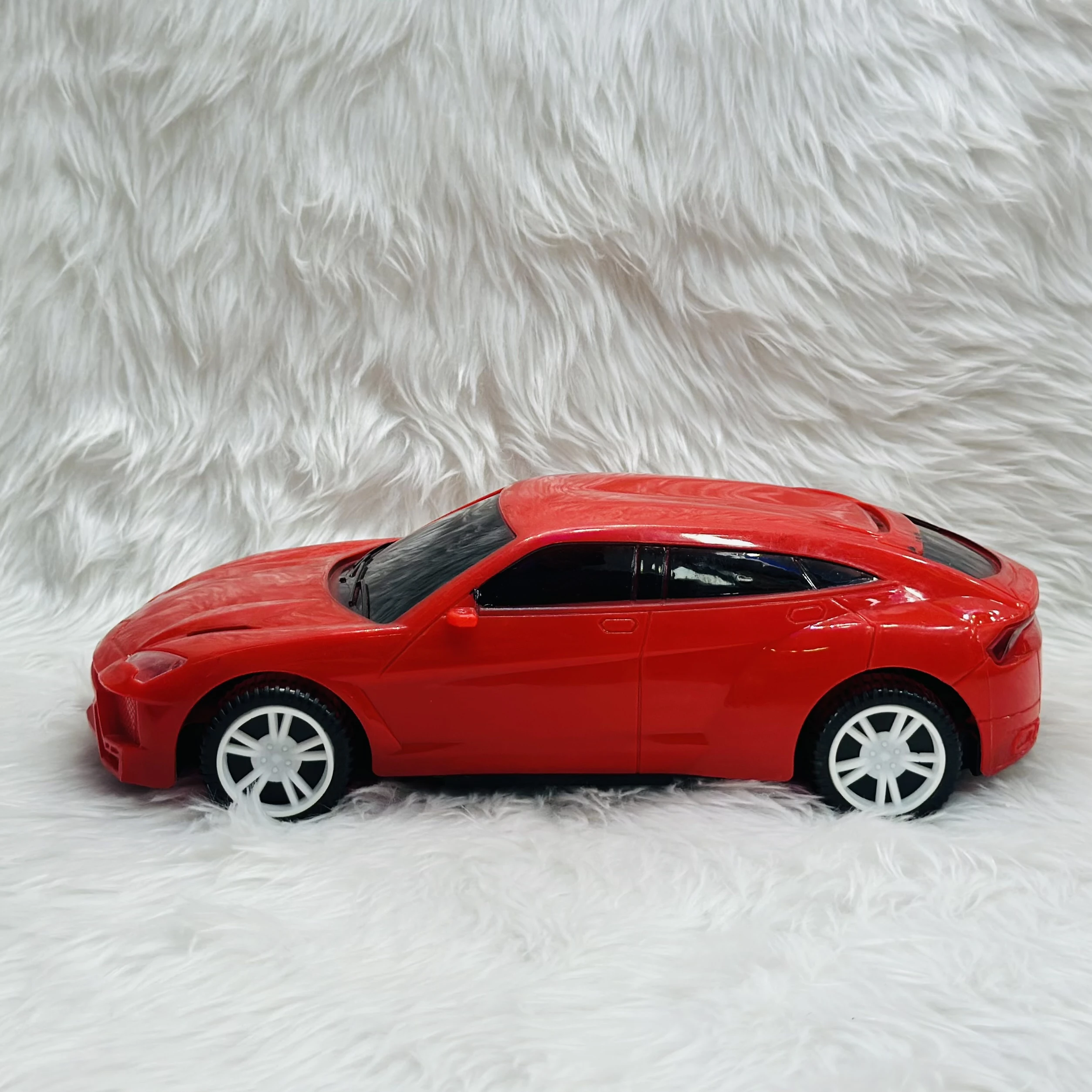 Red toy car, which is a model of a Lamborghini Urus SUV.