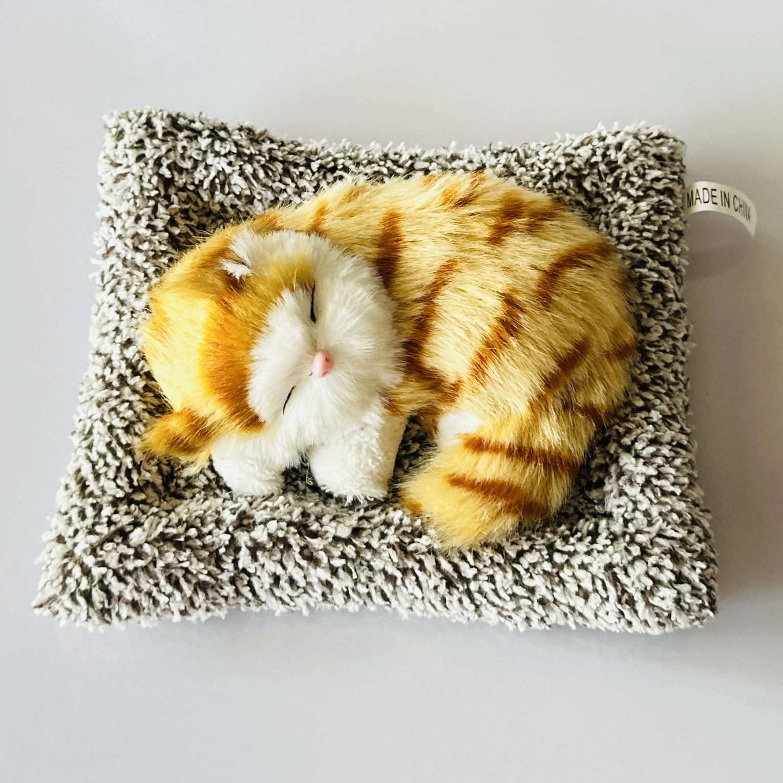 plush toy depicting a sleeping cat