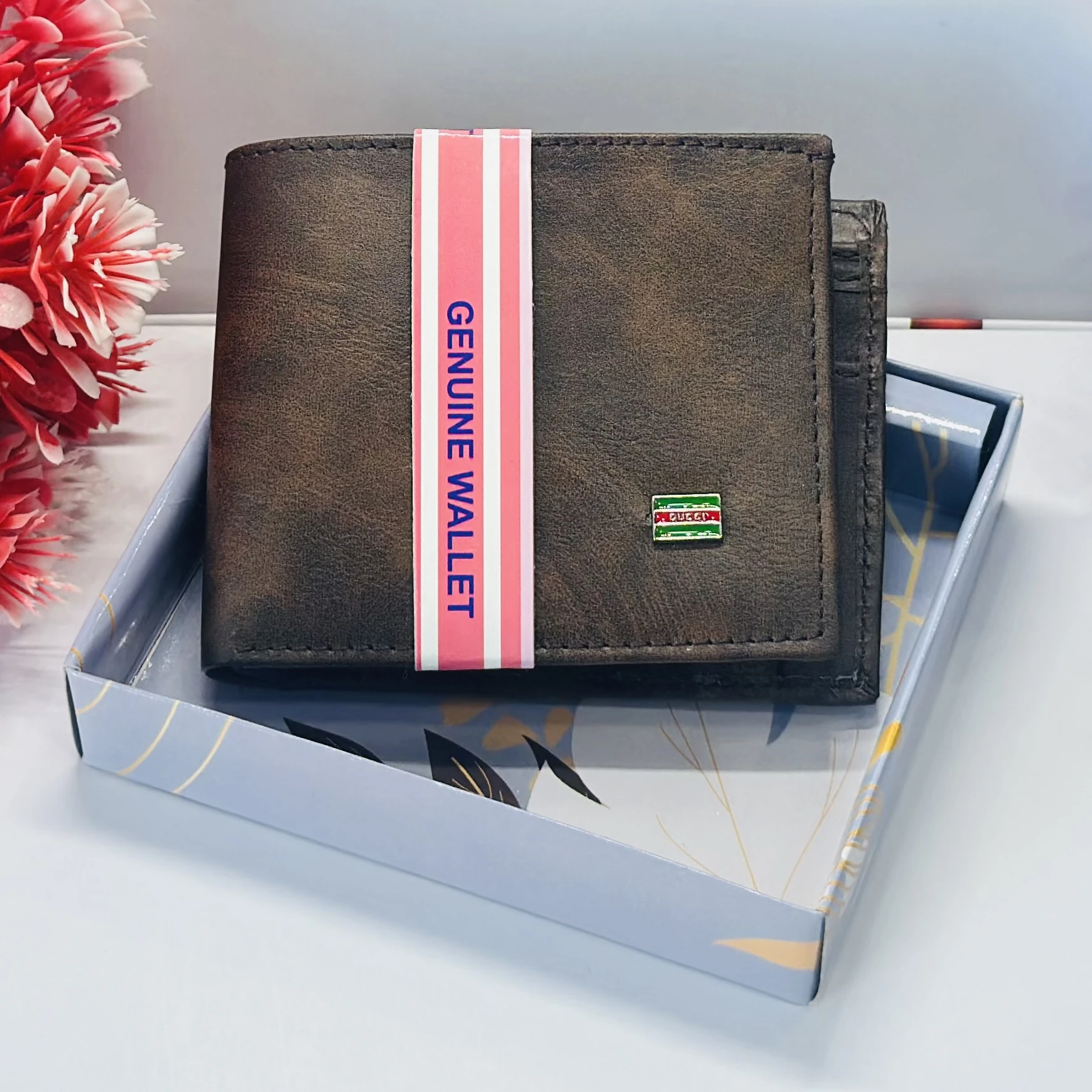 brown bifold wallet with "Genuine Wallet" text and a small "Queen" logo.