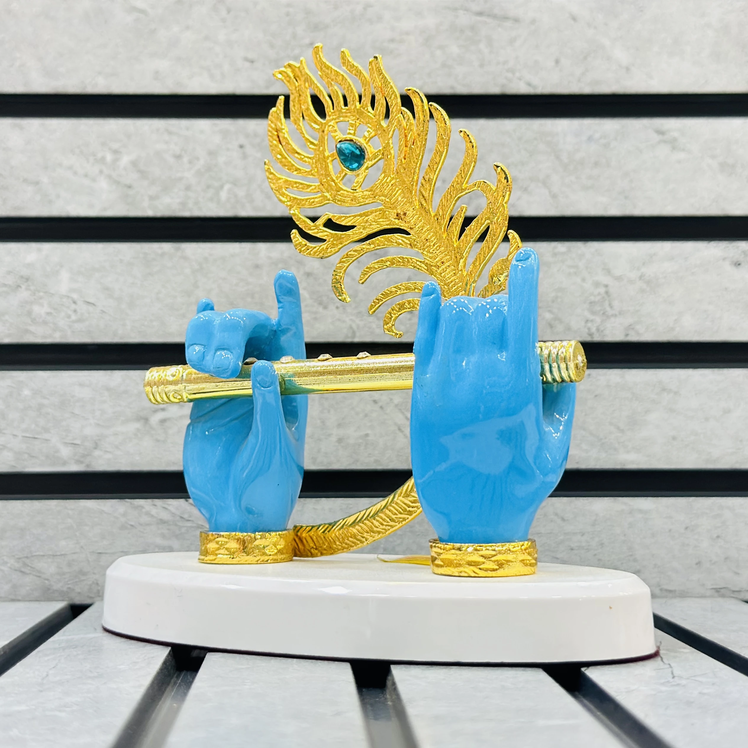 Gold plated Lord Krishna hands with flute and peacock feather figurine.