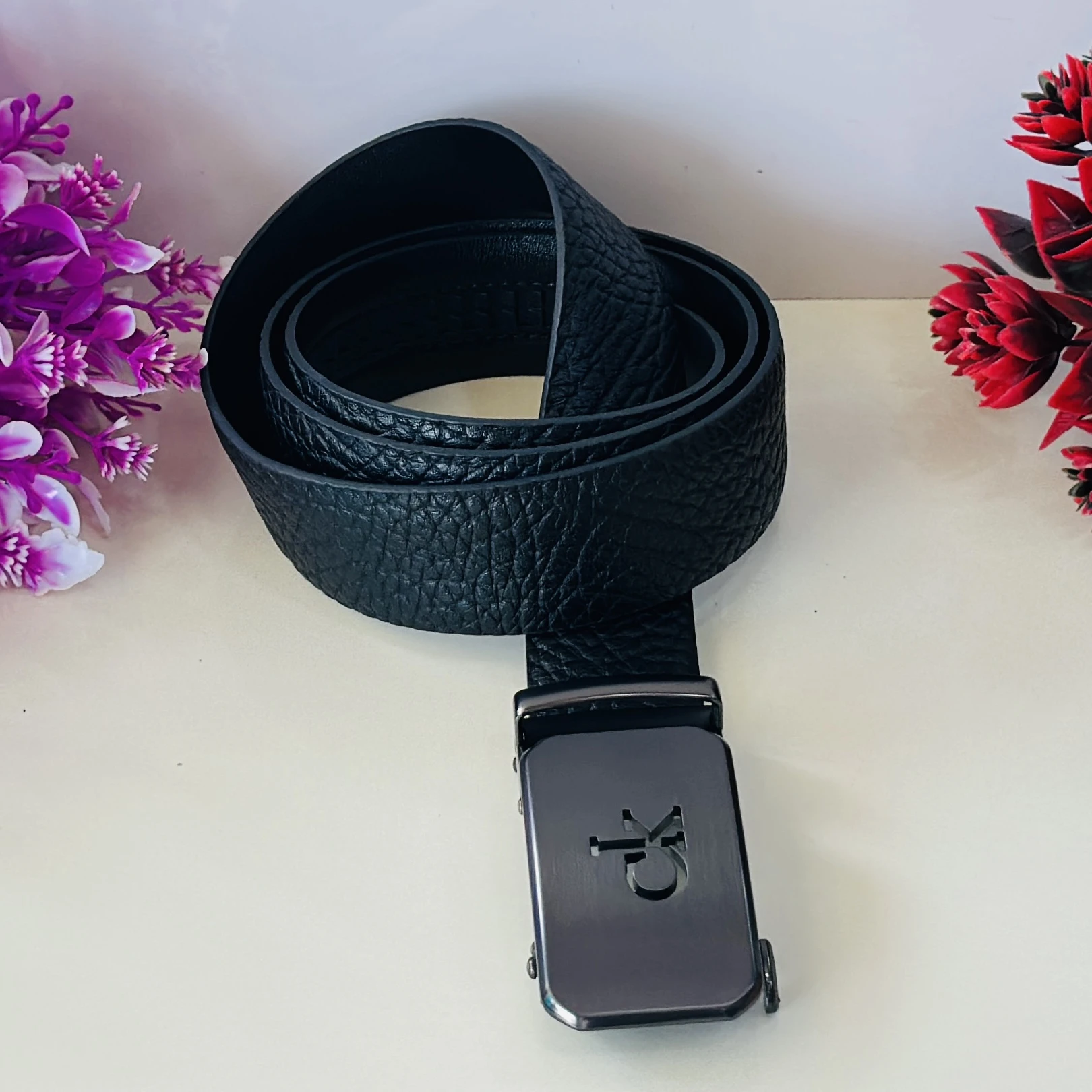 Calvin Klein black leather belt with a metal logo buckle.