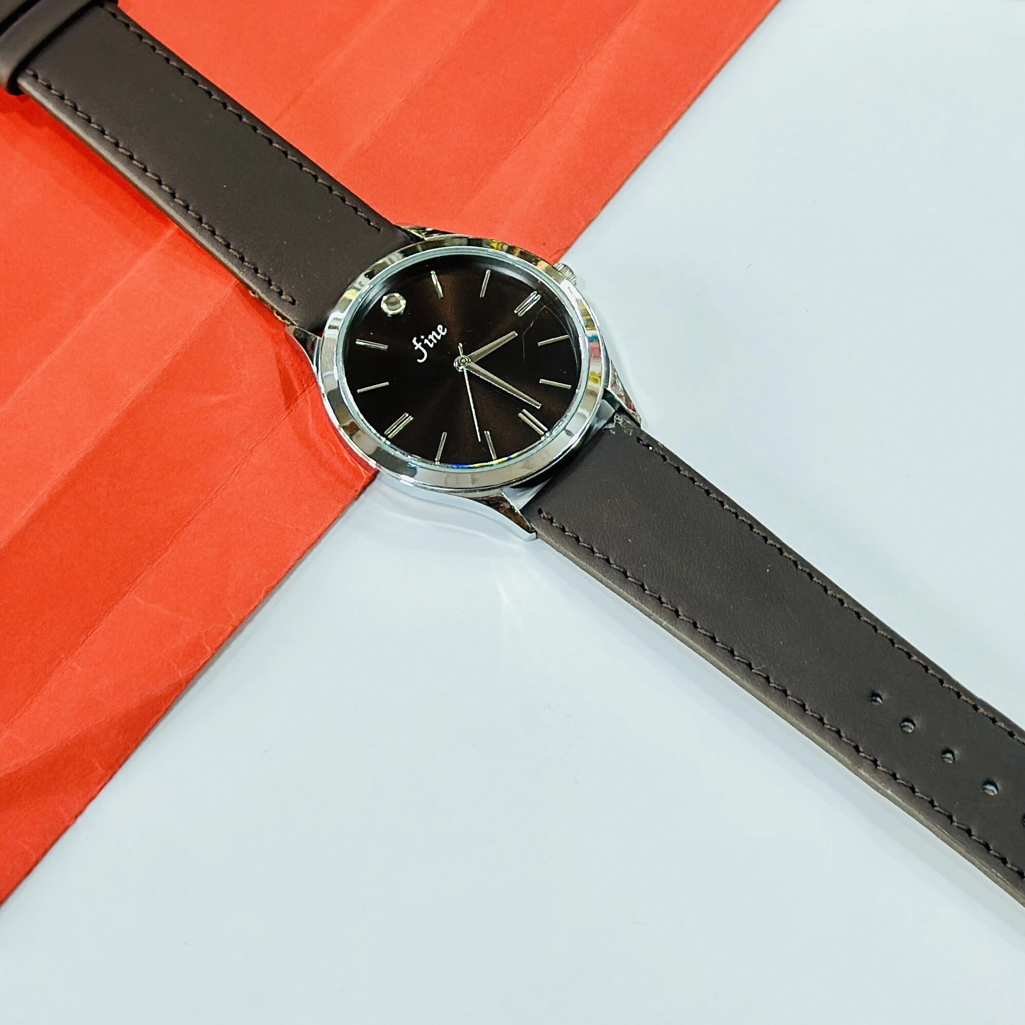 wristwatch with a brown leather band