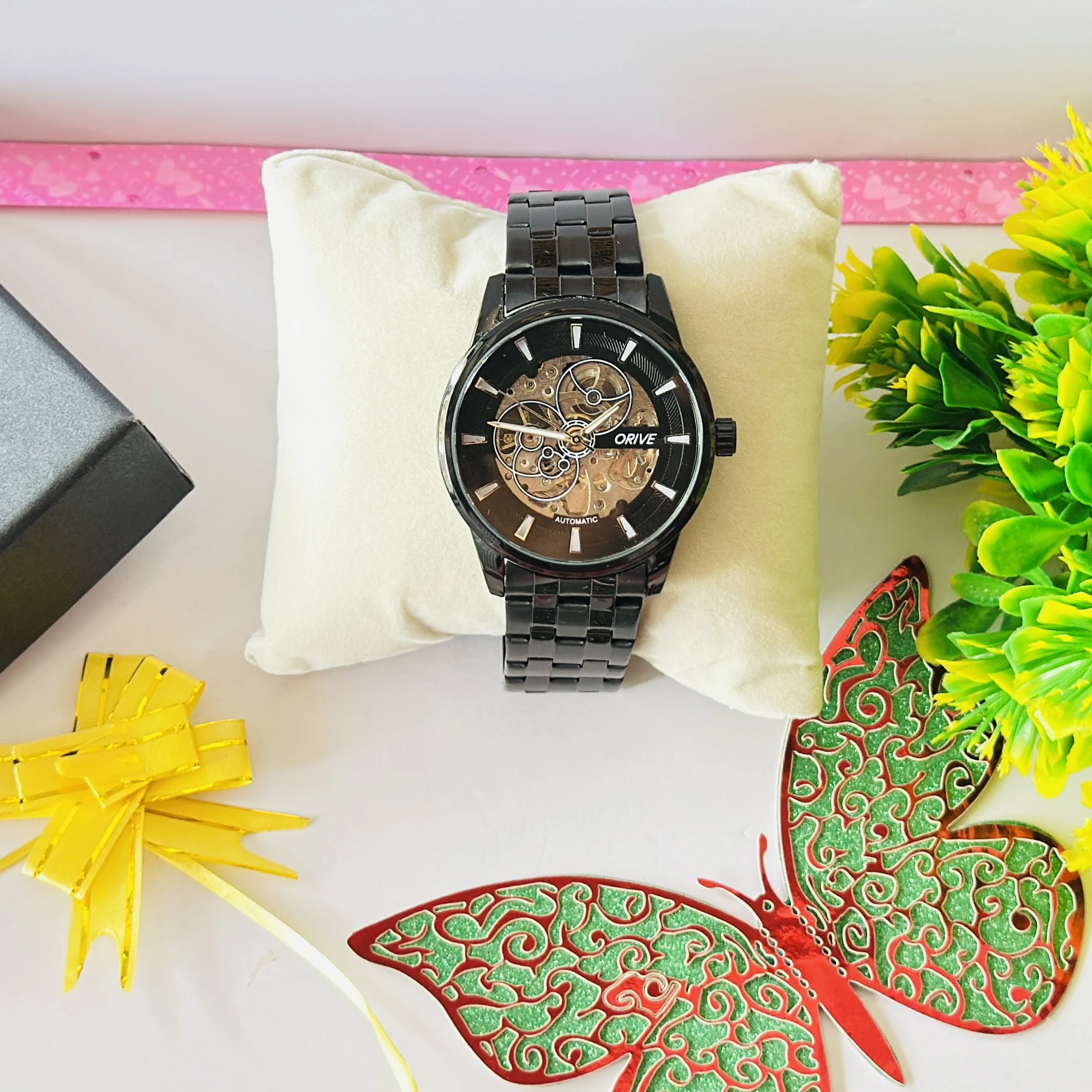 Black Fossil automatic watch with a skeleton dial, featuring a metallic strap.