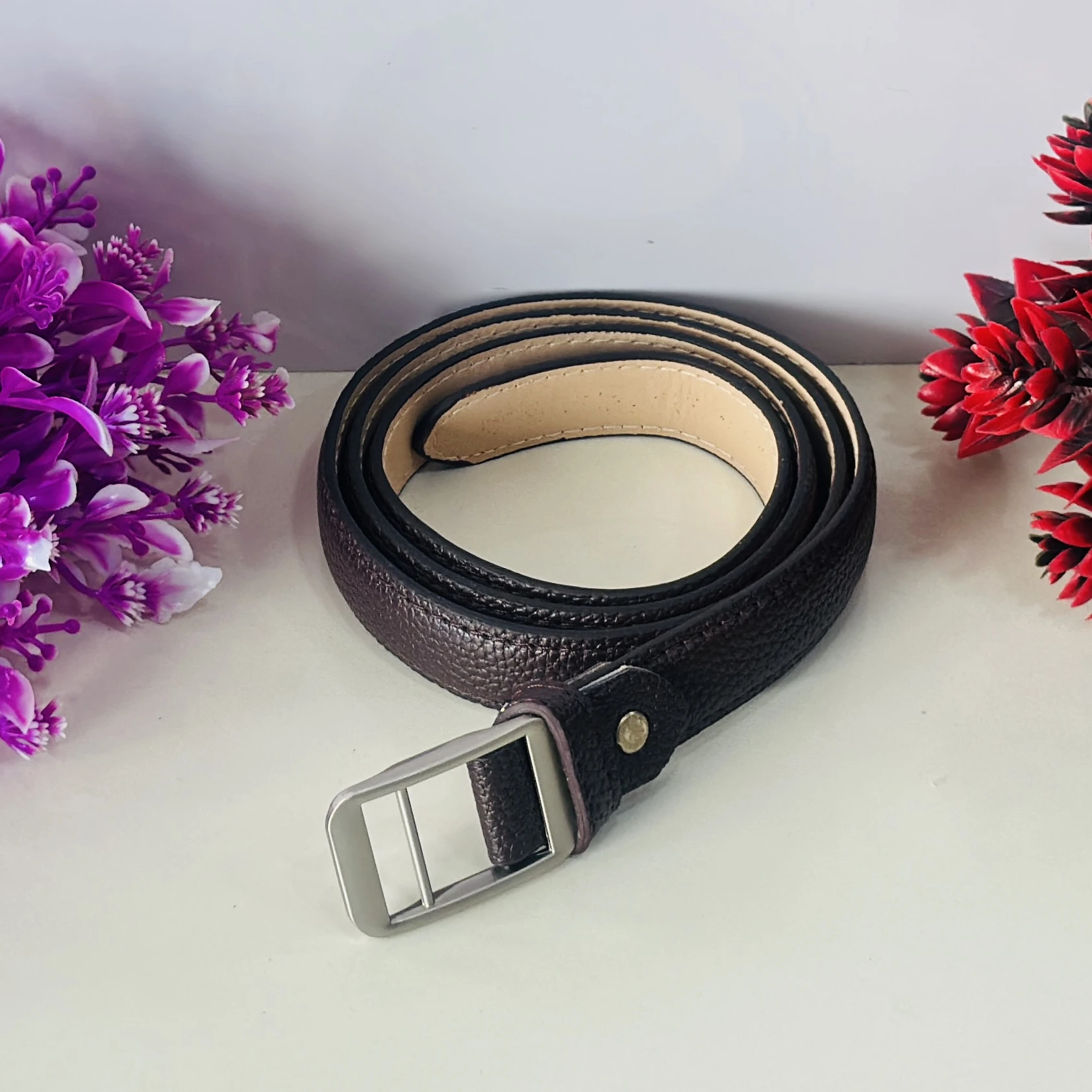 Brown leather belt with a silver-tone buckle.