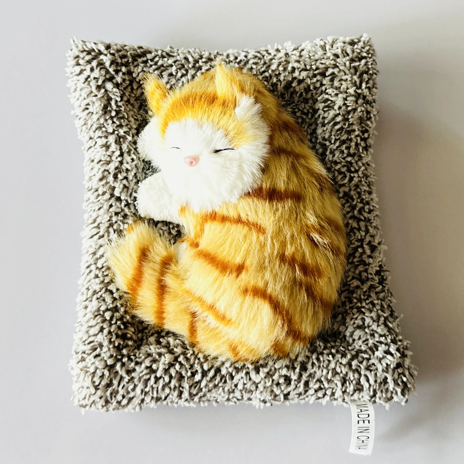 plush toy depicting a sleeping cat