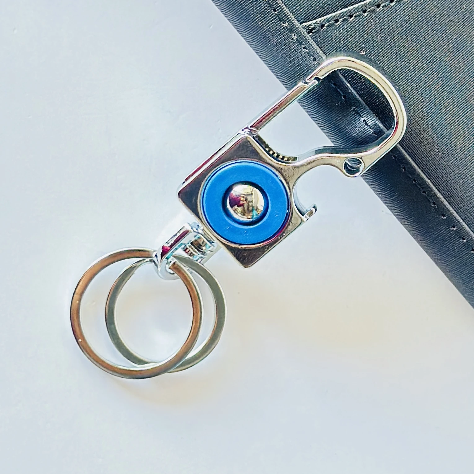 silver and blue metal accessory is an Omuda carabiner keychain