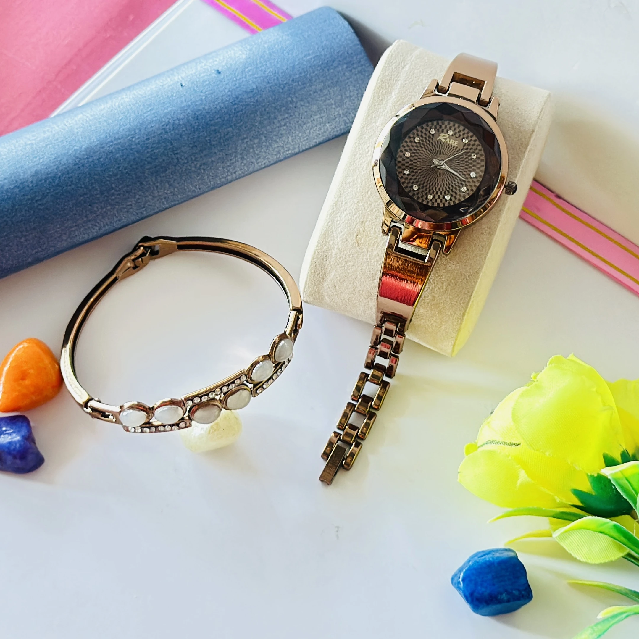 Rose gold-tone ladies wristwatch with a crystal-embellished round dial and bracelet strap.