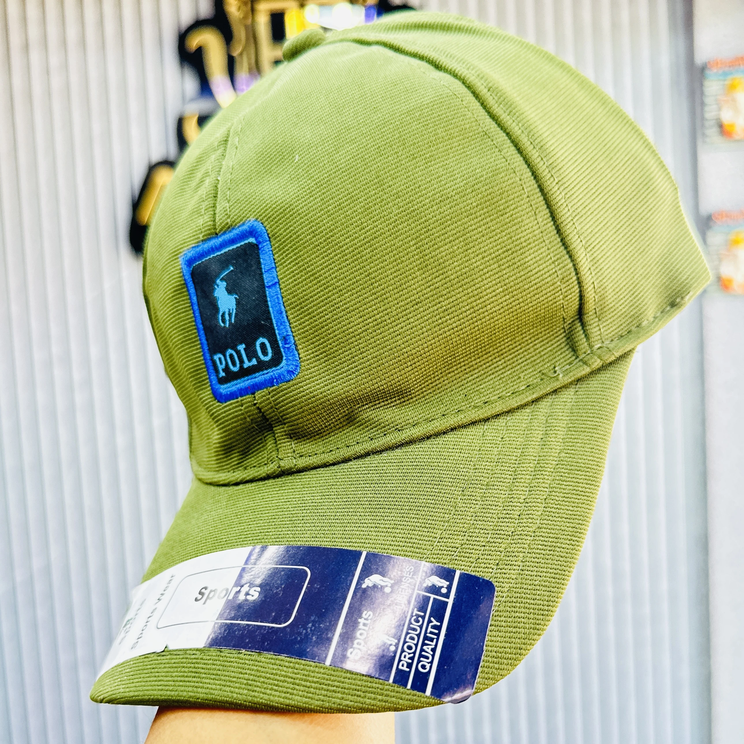 appears to be a green cotton blend baseball cap