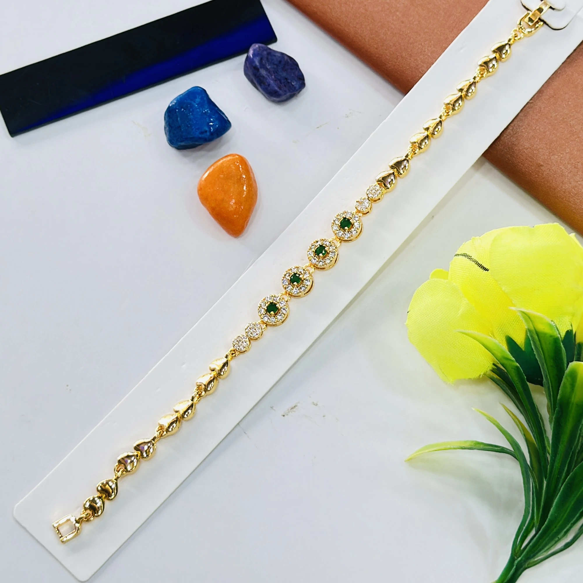 Gold plated bracelet with green and white stones