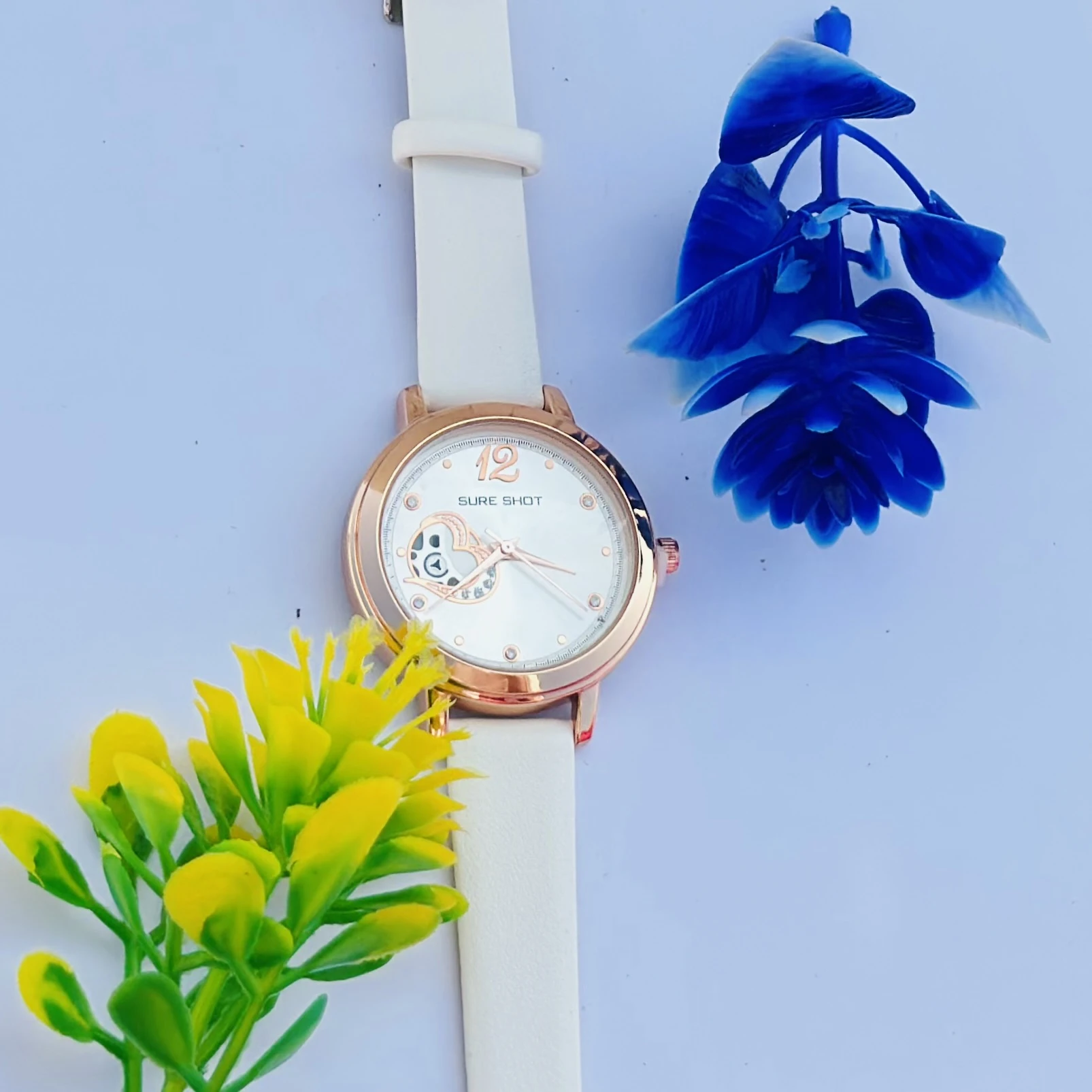 Sure Shot women's analog watch with a rose gold case, white dial, and white silicone strap