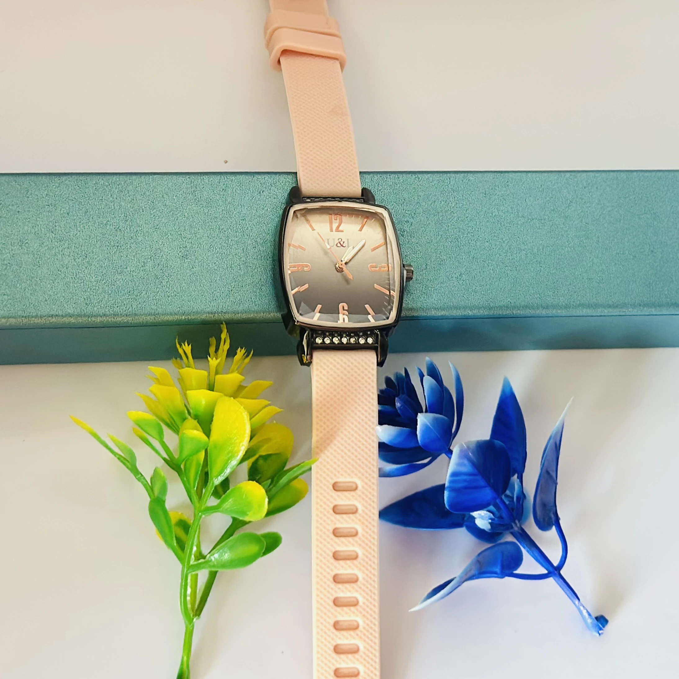 women's analog watch with a pink silicone strap and a rose gold-tone case and dial