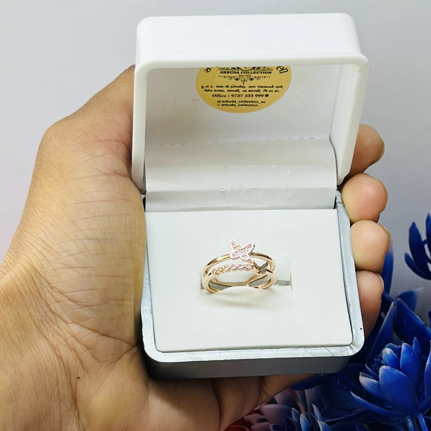 Rose gold plated cubic zirconia butterfly double band ring.