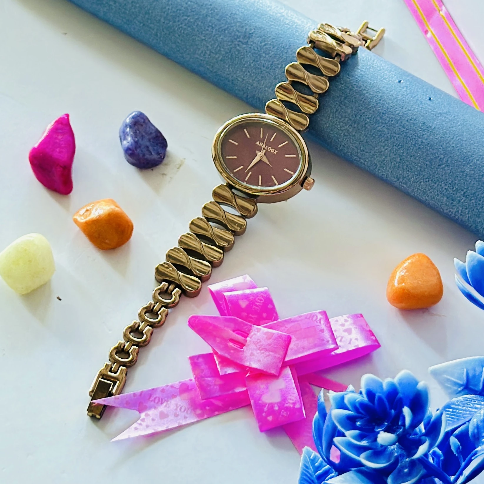 gold-tone Analogx brand women's analog wristwatch with a unique link bracelet.