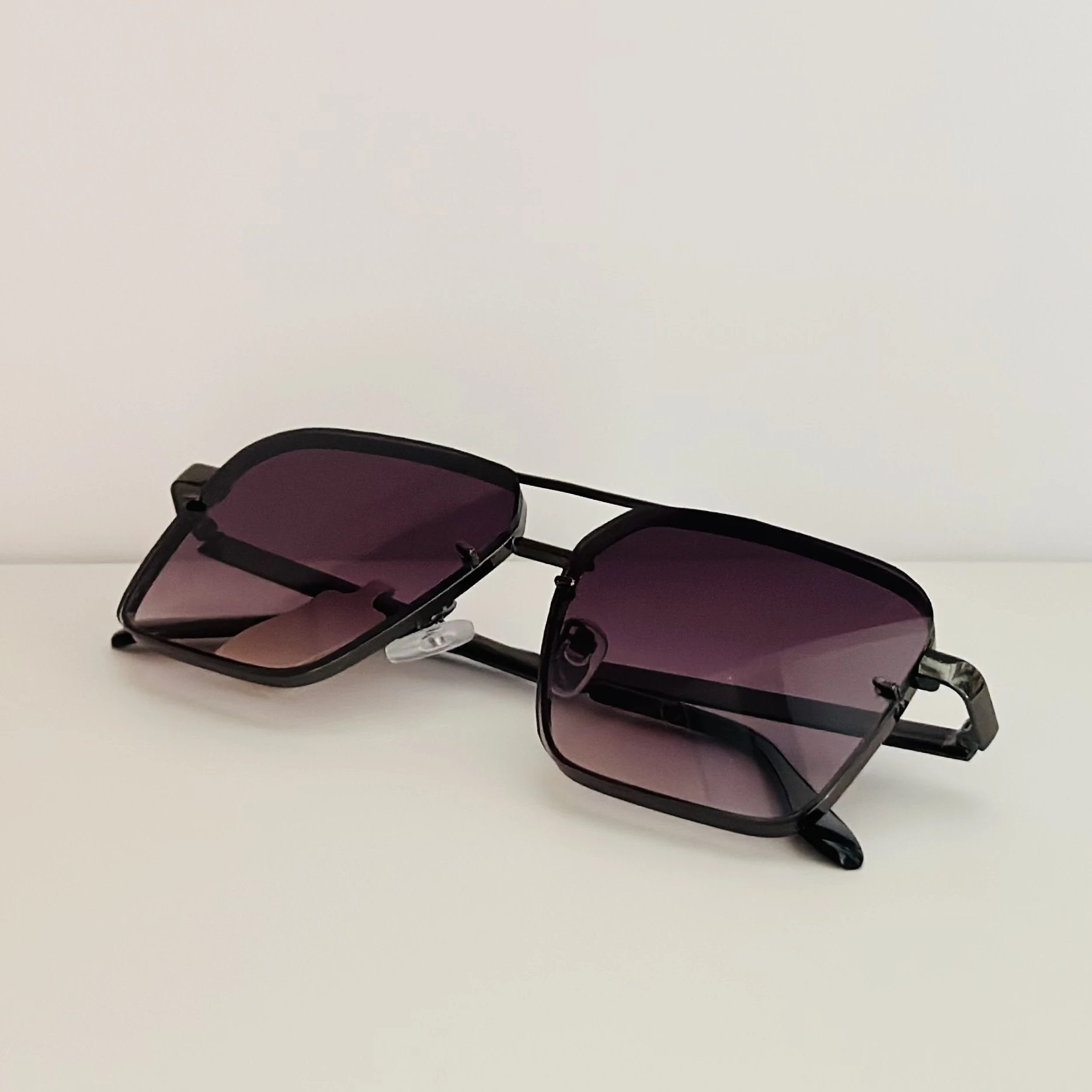 pair of square aviator gradient sunglasses with a black metal frame.