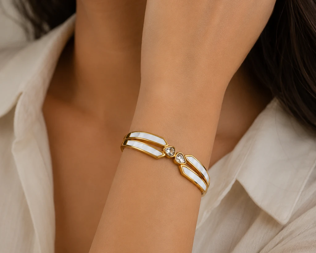 Gold tone hinged bangle bracelet