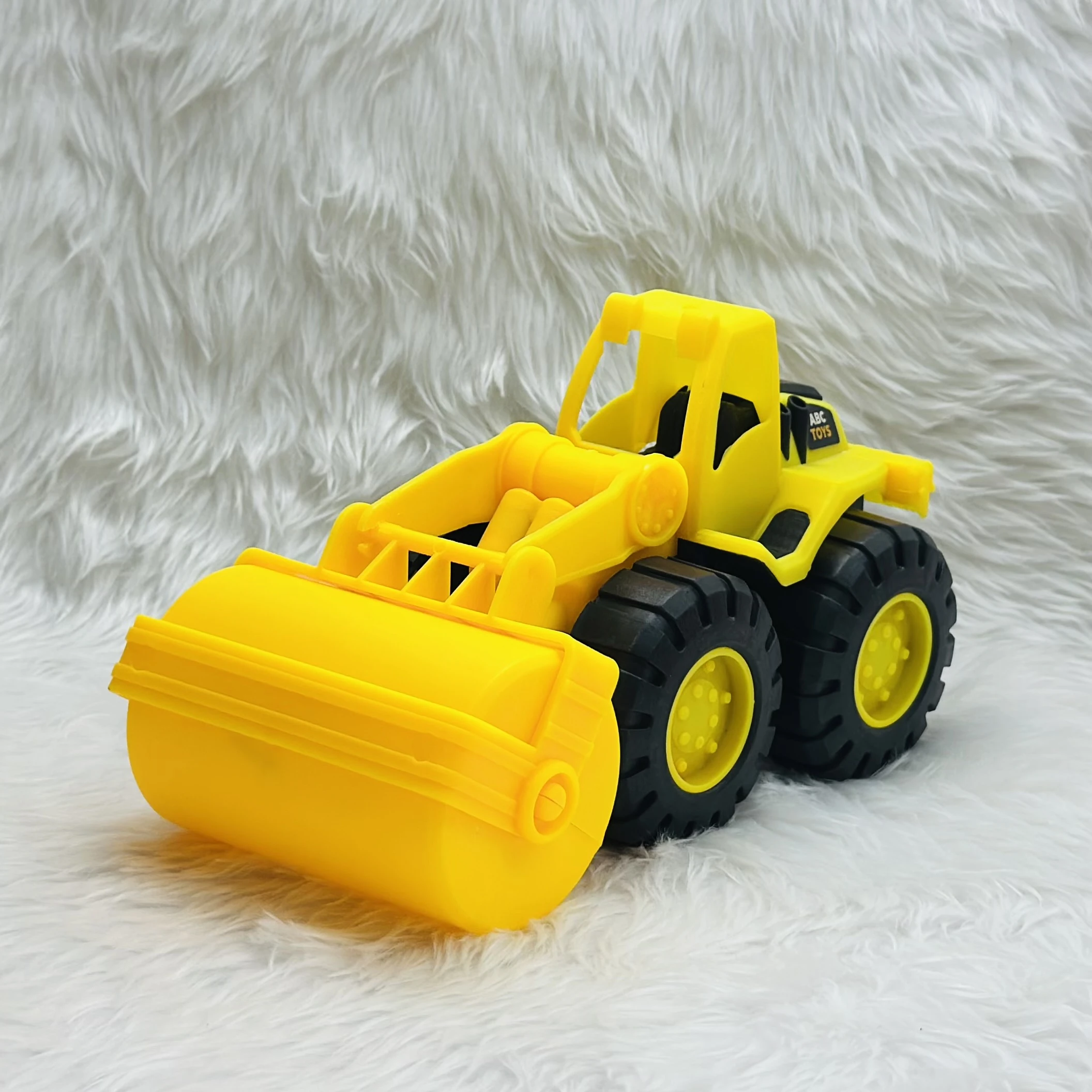 yellow toy construction vehicle, identified as a bulldozer or wheel loader,