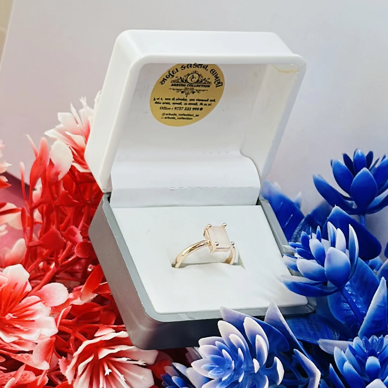 Rose gold-toned ring with a square-cut white stone.