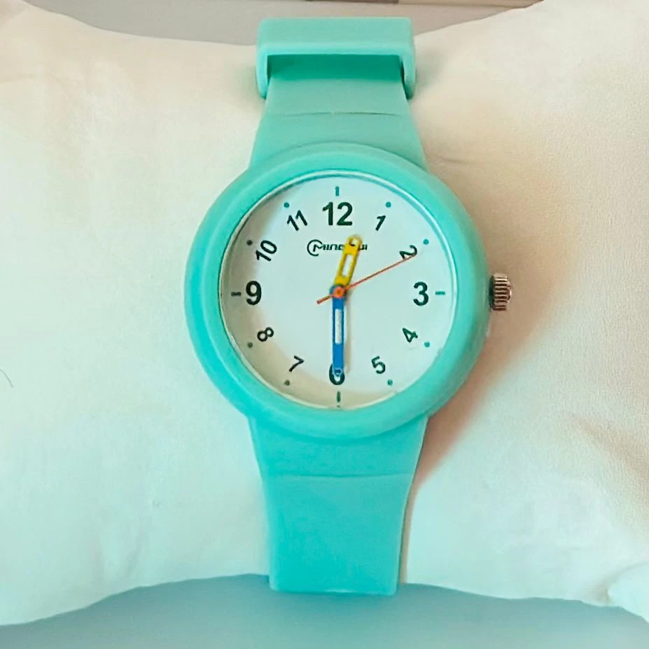 Mingrui analog quartz watch with a black silicone or plastic strap.
