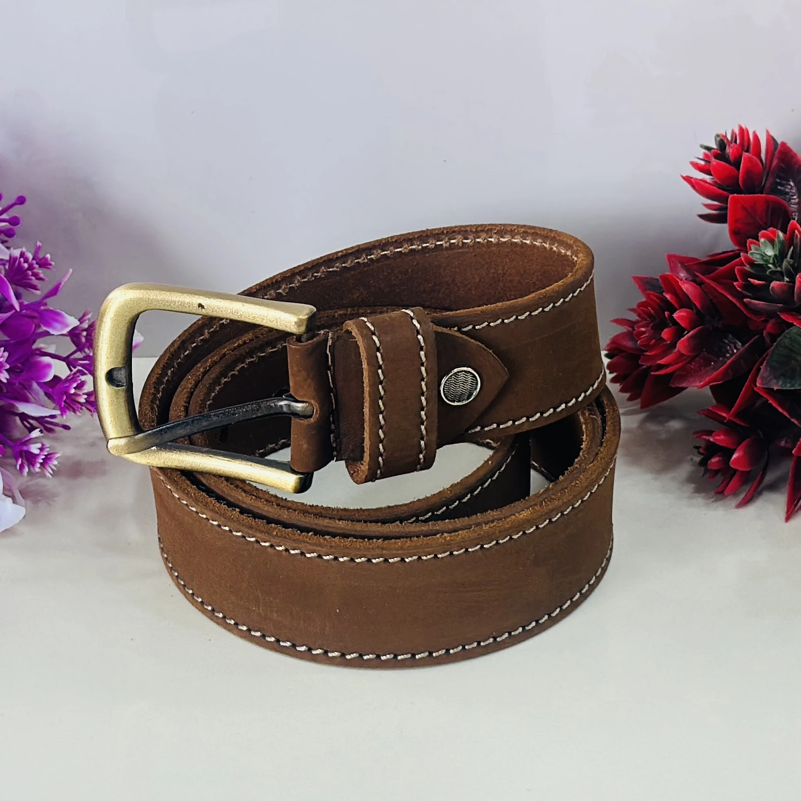 Brown genuine leather belt with a pin buckle closure.