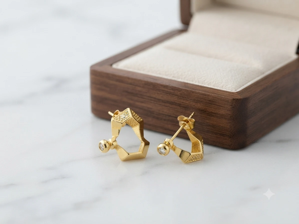 Gold geometric hoop earrings are similar to the Guess Huggie Me Hexagon style