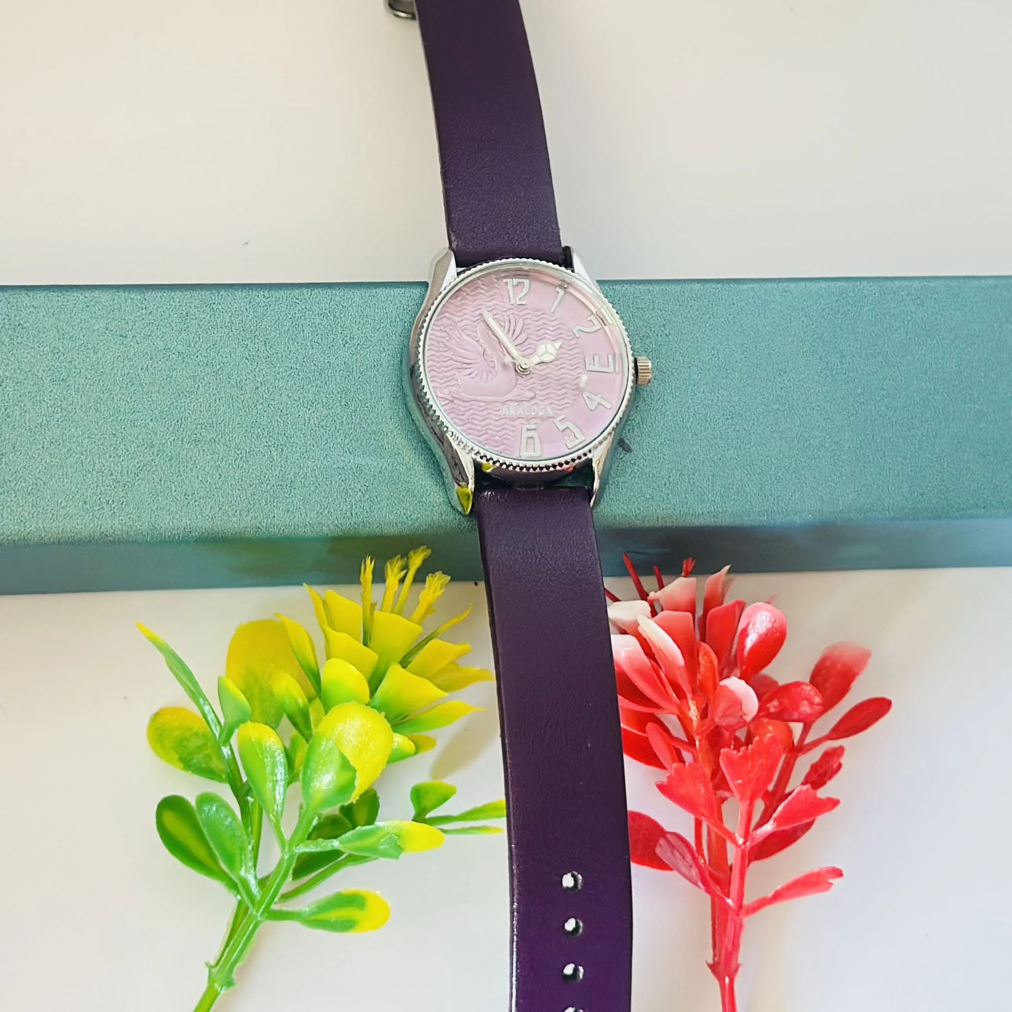 Sure Shot analog watch with a black leather band and silver-tone case.