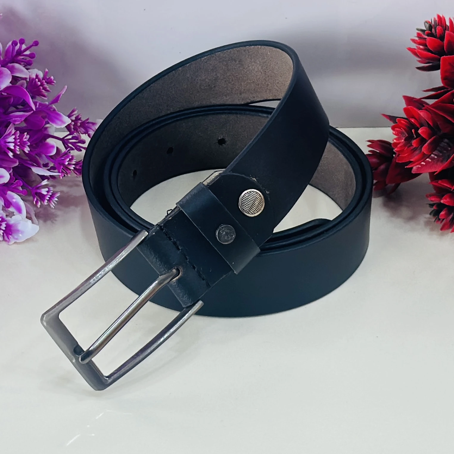 Black leather belt with a silver-tone pin buckle.