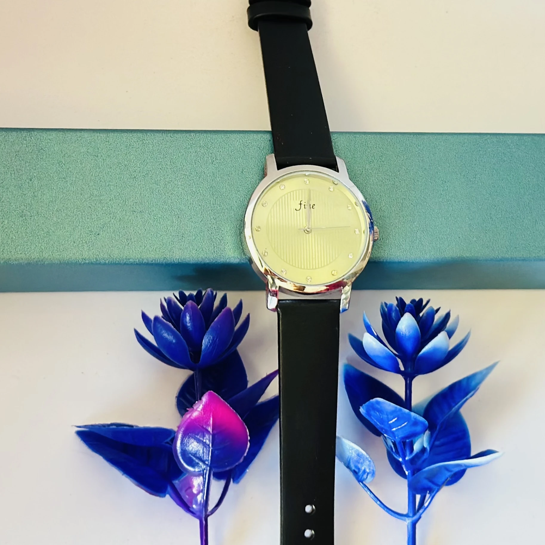 women's round leather watch in silver and black with a white dial