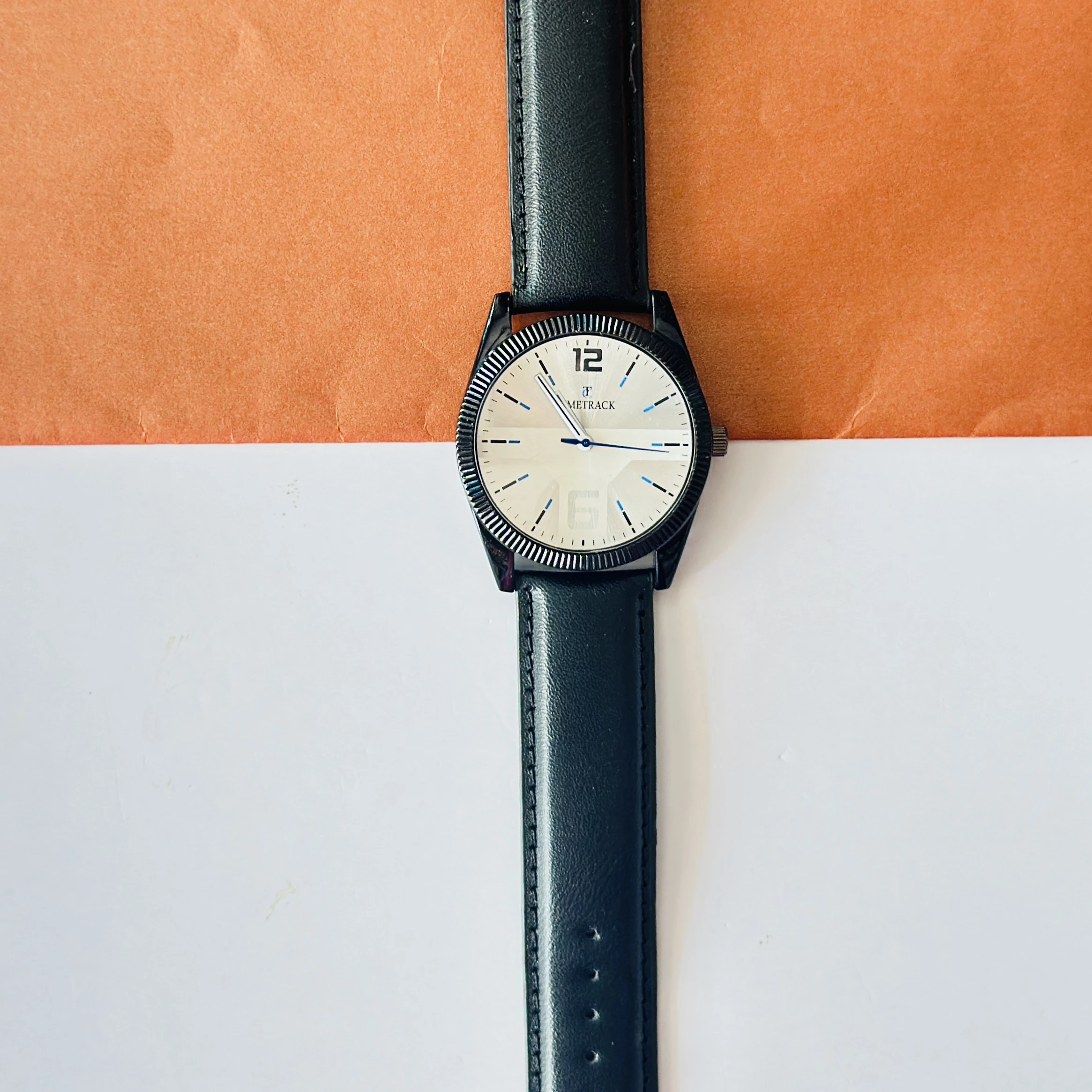Timrack analog wristwatch featuring a silver-toned bezel, a black dial