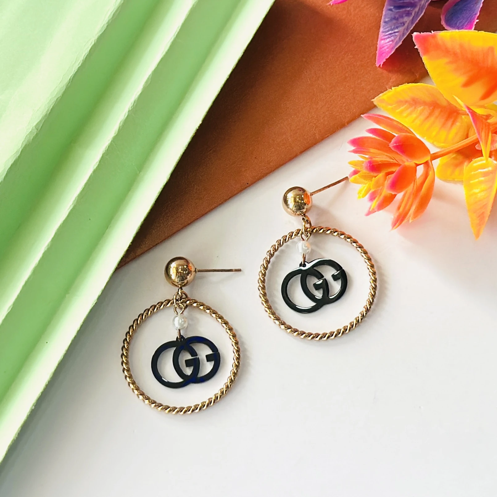 Gold toned and black fashion hoop earrings