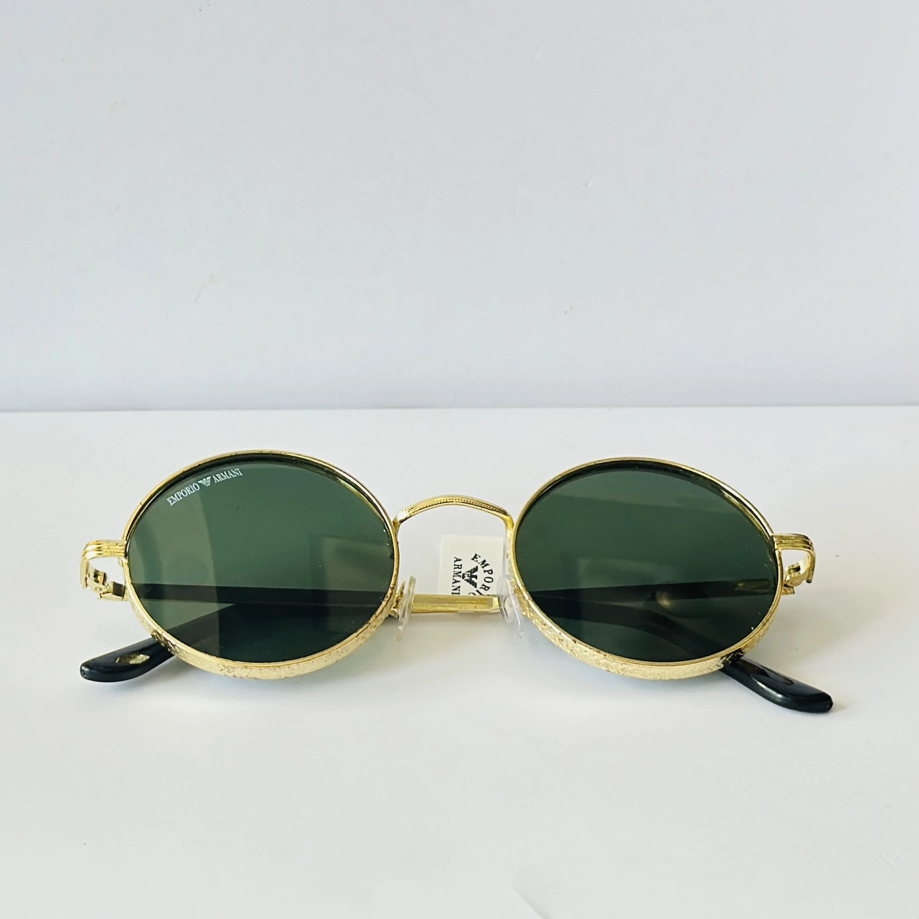 sunglasses are Emporio Armani round-frame
