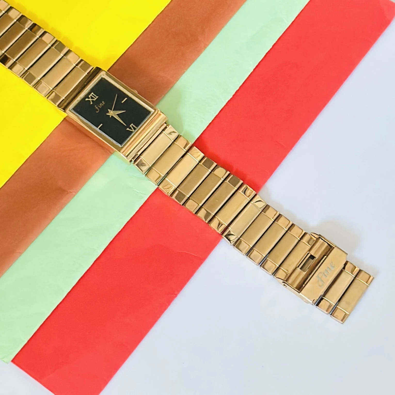 Gold -tone analog quartz watch with a metal strap.