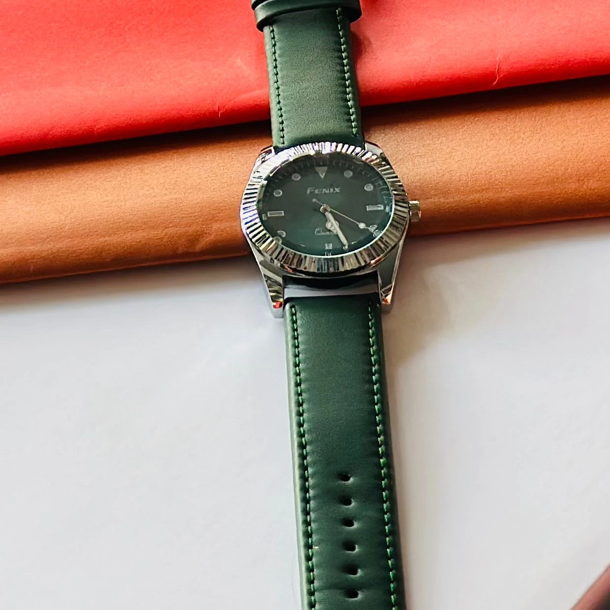 Round analog watch with a Green  leather strap