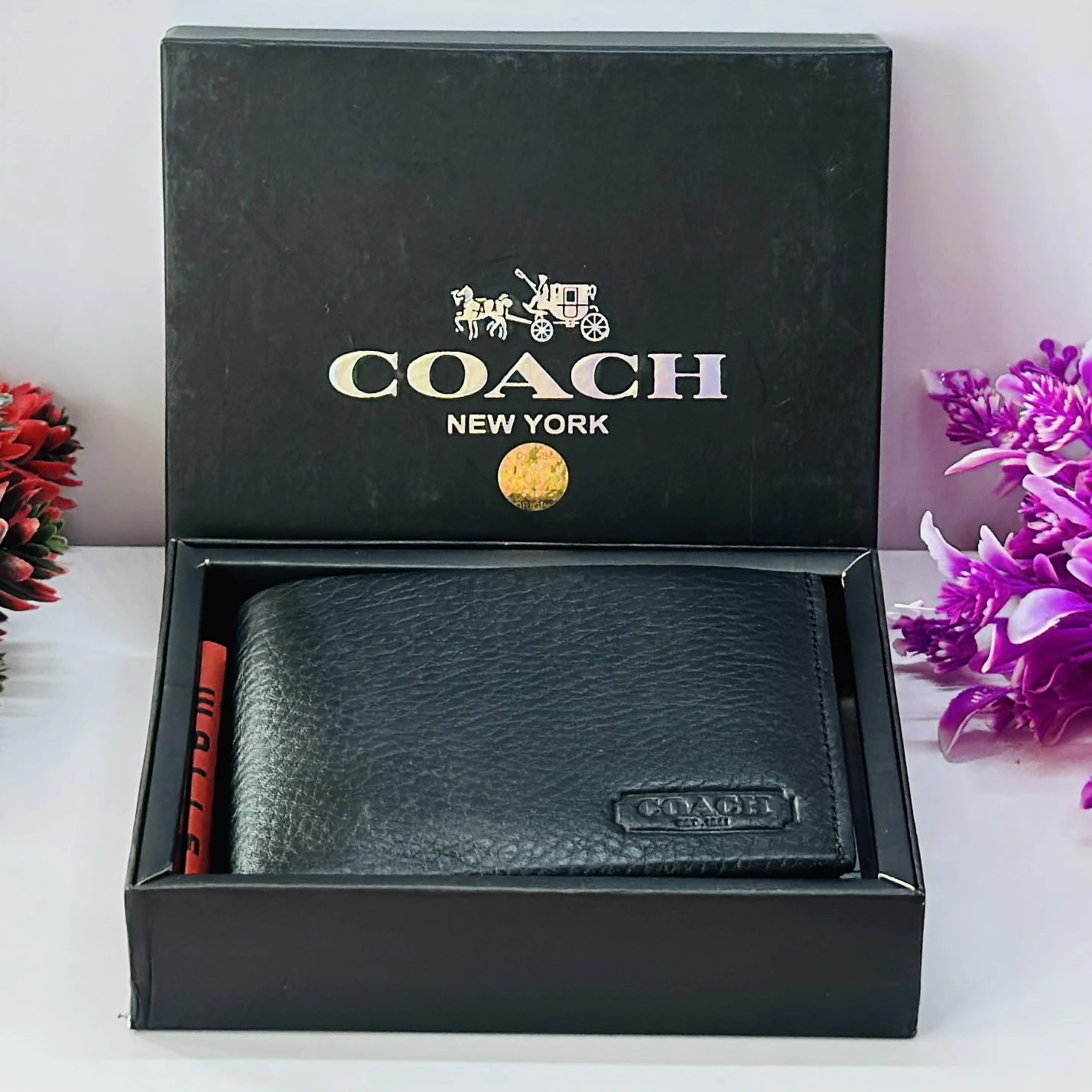 Coach men's black leather slim bifold wallet.