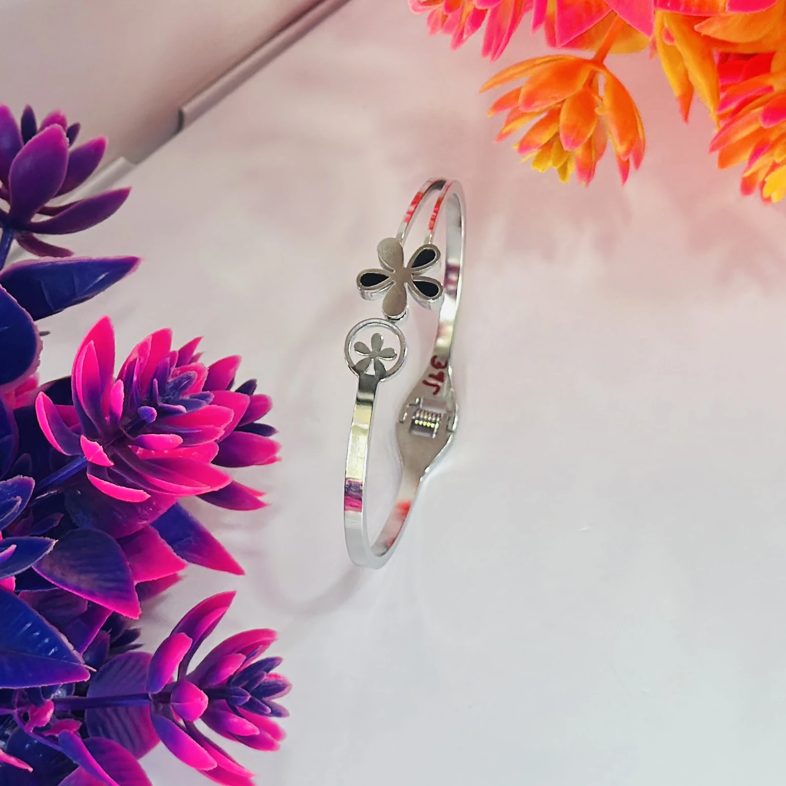 Silver plated anti-tarnish clover floral openable bangle-style bracelet.