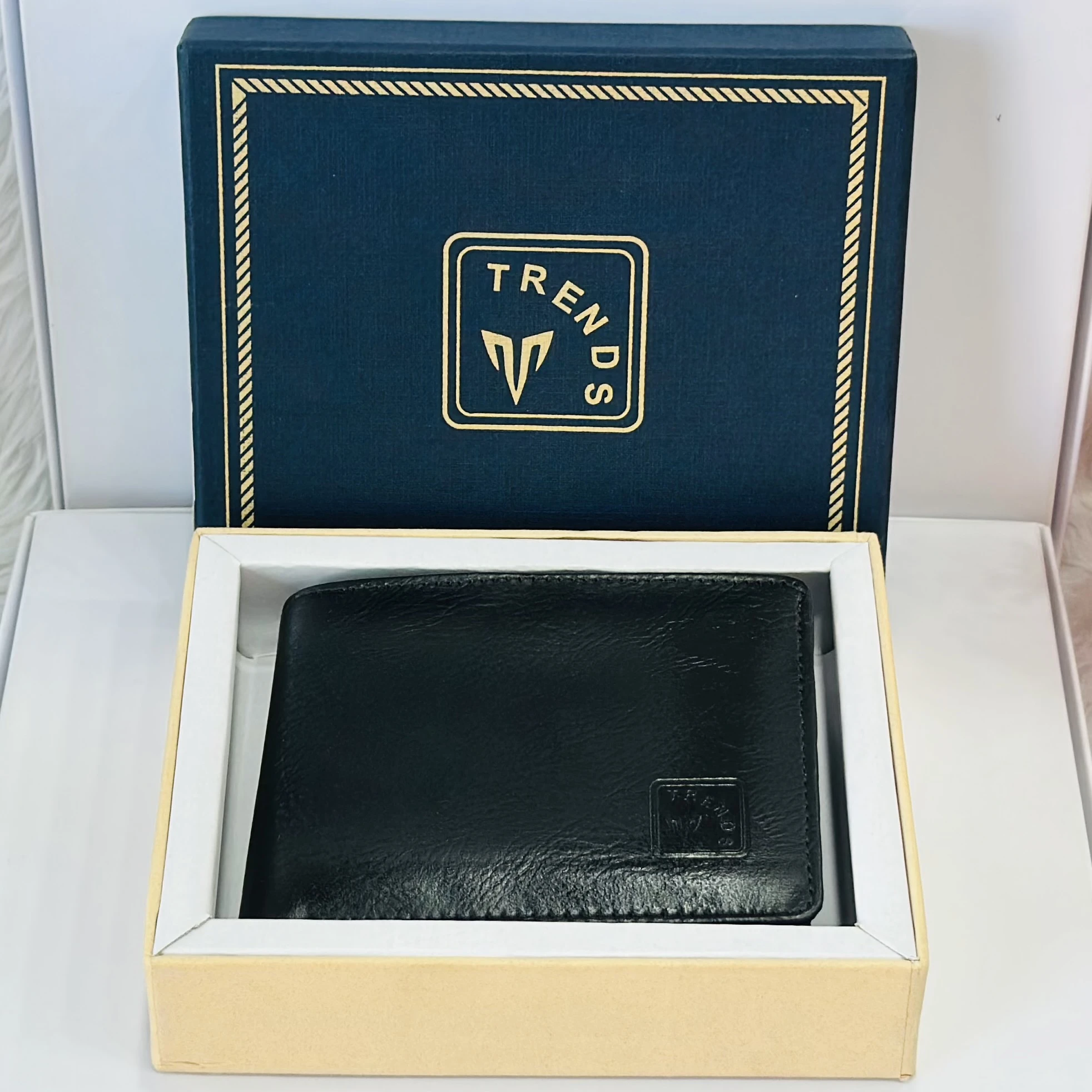 Black leather bifold wallet by the brand Trends.