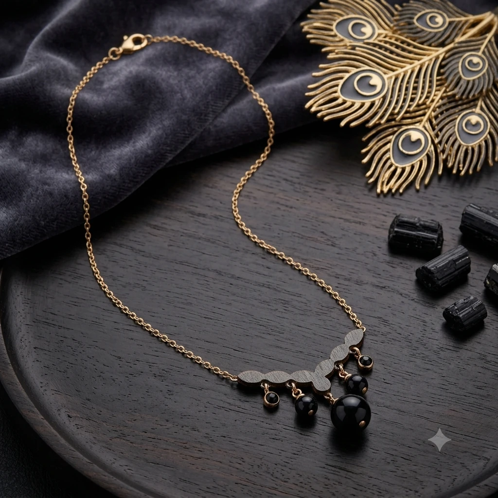 Rose gold-plated pendant necklace with a leaf-motif pendant and black beads.