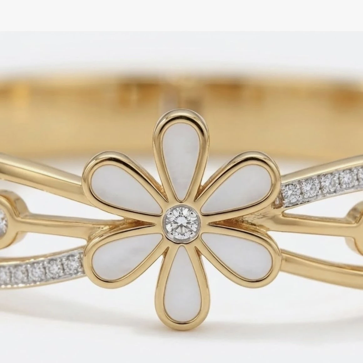 Gold tone hinged bangle bracelet