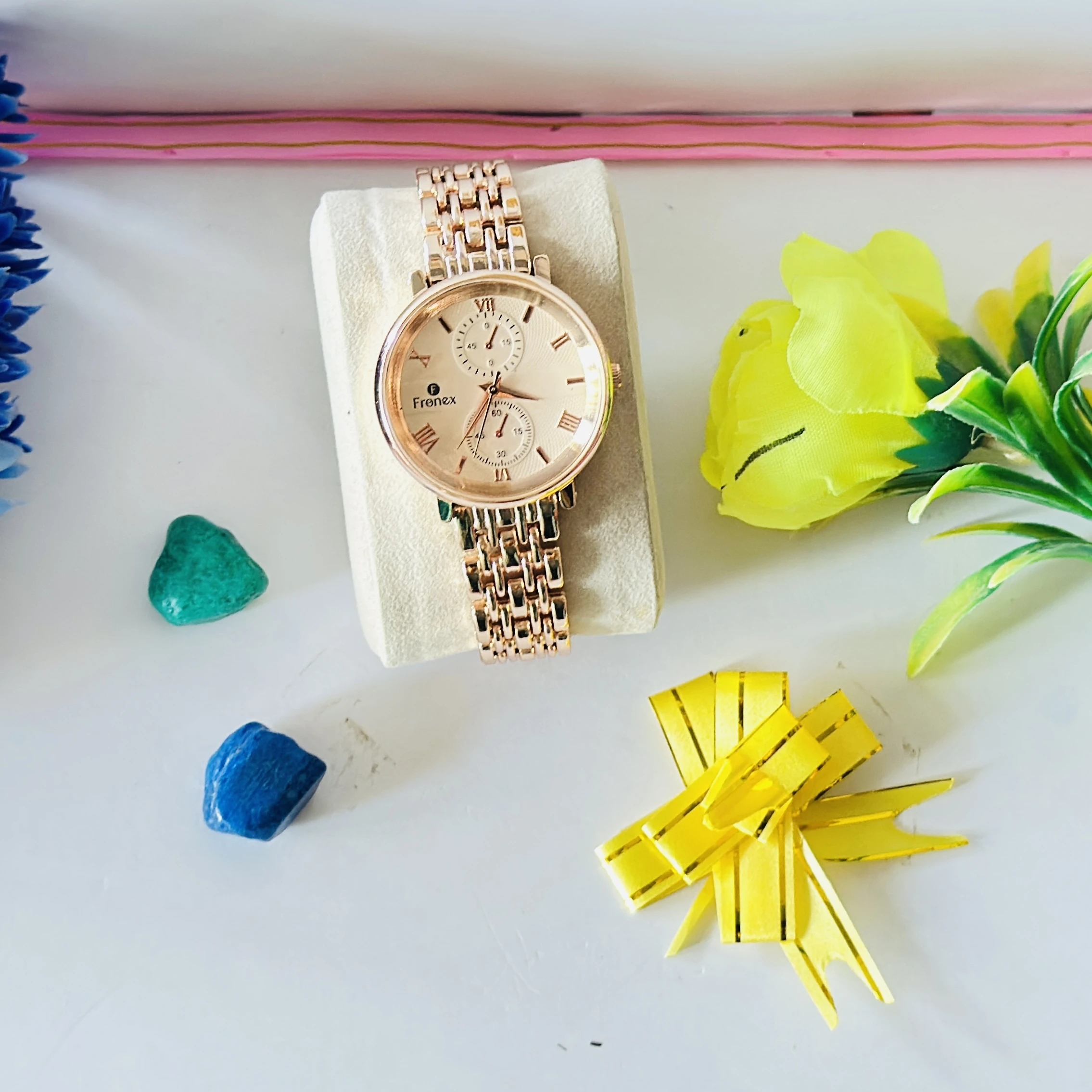 Frenex brand rose gold analog wristwatch with a metal strap