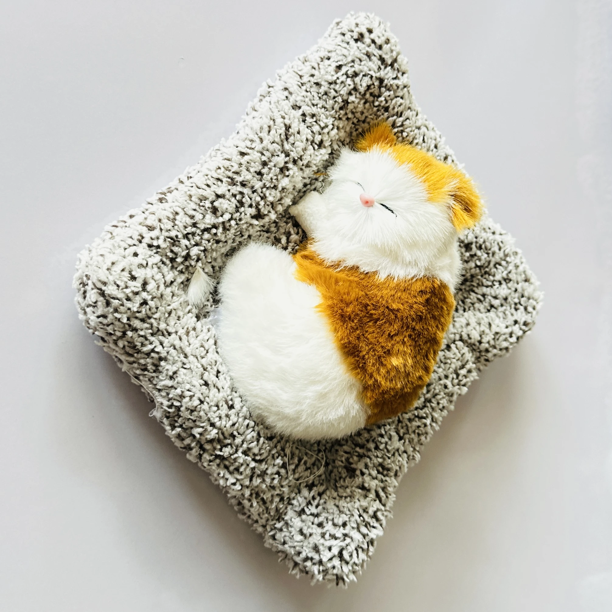 plush toy depicting a sleeping cat