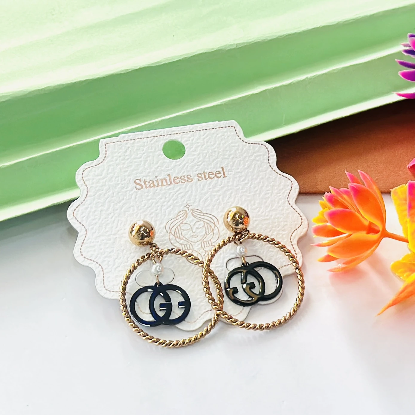 Gold toned and black fashion hoop earrings