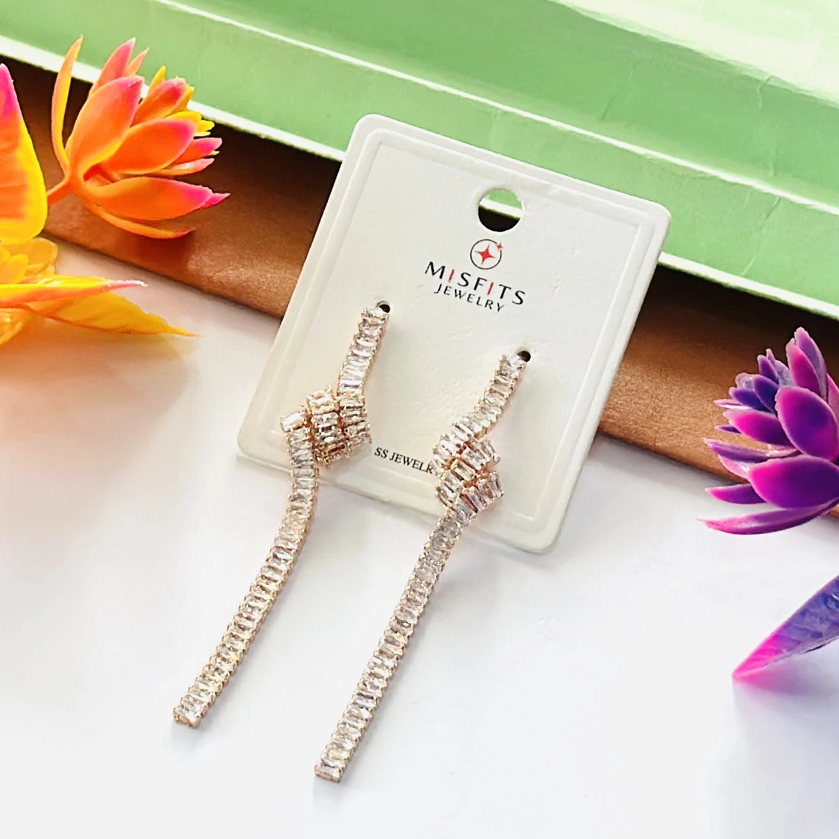 Lovisa gold-plated cubic zirconia baguette knotted drop earrings.