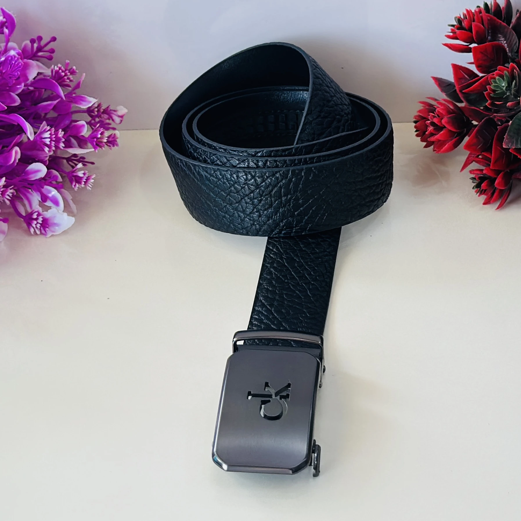 Calvin Klein black leather belt with a metal logo buckle.